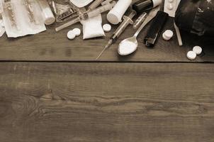 A lot of narcotic substances and devices for the preparation of drugs lie on an old wooden table photo