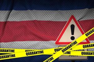 Costa Rica flag and Covid-19 quarantine yellow tape. Coronavirus or 2019-nCov virus photo