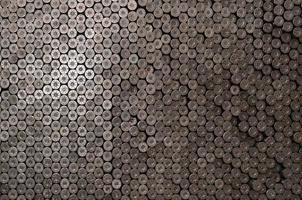 Pattern of 12 gauge cartridges for shotgun bullets. Shells for hunting rifle close up. Backdrop for shooting range or ammunition trade concepts photo