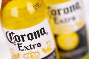 KHARKOV, UKRAINE - DECEMBER 9, 2020 Two Bottles of Corona Extra Beer. Corona produced by Grupo Modelo with Anheuser Busch InBev most popular imported beer in the US photo
