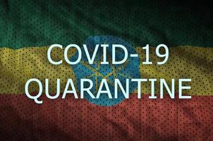 Ethiopia flag and Covid-19 quarantine inscription. Coronavirus or 2019-nCov virus photo