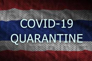 Thailand flag and Covid-19 quarantine inscription. Coronavirus or 2019-nCov virus photo