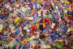 KHARKOV, UKRAINE - AUGUST 10, 2021 Big pile of various wrappings and empty disposable packages and cups from famous branded food production photo