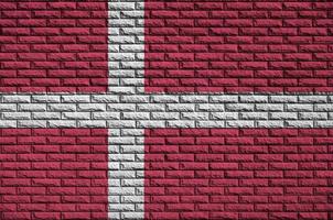 Denmark flag is painted onto an old brick wall photo