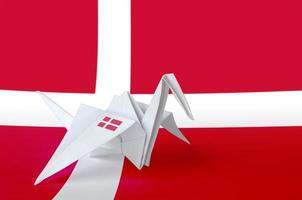 Denmark flag depicted on paper origami crane wing. Handmade arts concept photo