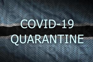 Botswana flag and Covid-19 quarantine inscription. Coronavirus or 2019-nCov virus photo