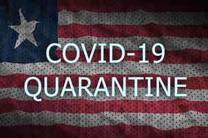 Liberia flag and Covid-19 quarantine inscription. Coronavirus or 2019-nCov virus photo