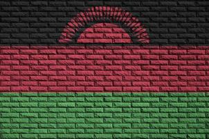 Malawi flag is painted onto an old brick wall photo