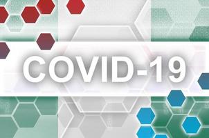 Nigeria flag and futuristic digital abstract composition with Covid-19 inscription. Coronavirus outbreak concept photo