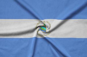 Nicaragua flag  is depicted on a sports cloth fabric with many folds. Sport team banner photo