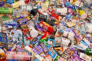 KHARKOV, UKRAINE - AUGUST 10, 2021 Big pile of various wrappings and empty disposable packages and cups from famous branded food production photo