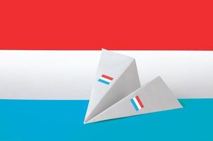 Luxembourg flag depicted on paper origami airplane. Handmade arts concept photo