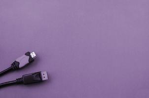 Audio video HDMI computer cable plug and 20-pin male DisplayPort gold plated connector for a flawless connection on purple backdrop photo