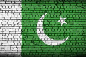 Pakistan flag is painted onto an old brick wall photo