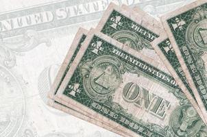 1 US dollar bills lies in stack on background of big semi-transparent banknote. Abstract presentation of national currency photo