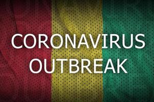 Guinea flag and Coronavirus outbreak inscription. Covid-19 or 2019-nCov virus photo