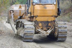 Quarry aggregate with heavy duty machinery. Caterpillar loader Excavator with backhoe driving to construction site quarry photo