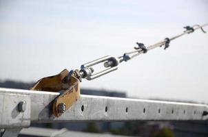 Rope lockers in rear beam of suspended wire rope platform for facade works on high multistorey buildings. Rope lockers blocks kink for safety platform usage photo
