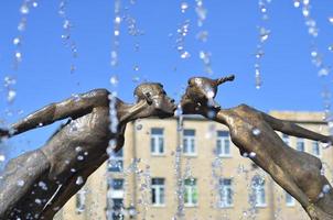 Monument to lovers in Kharkov, Ukraine - is an arch formed by the flying, fragile figures of a young man and a girl, merged into a kiss photo