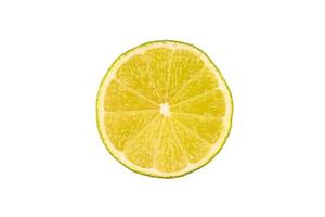 Slice of green lime on light white background. Fresh fruit with copy space photo