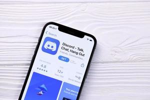 KHARKOV, UKRAINE - MARCH 5, 2021 Discord icon and application from App store on iPhone 12 pro display screen on white table photo