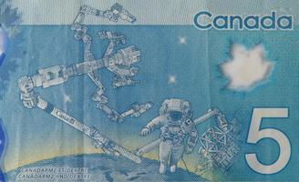 Dextre and canadarm2 on Canada 5 Dollars 2013 Polymer Banknote fragment photo