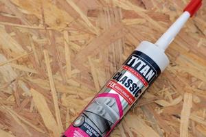 KHARKIV, UKRAINE - MAY 02, 2021 Assembly adhesive tytan professional classic fix invisible seam by Selena Group. Selena Group is a global leader and distributor of construction chemicals photo