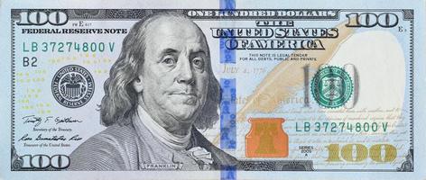 Portrait of US president Benjamin Franklin on 100 dollars banknote closeup macro fragment. United states hundred dollars money bill photo