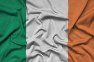 Ireland flag  is depicted on a sports cloth fabric with many folds. Sport team banner photo