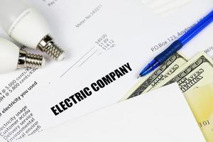 Abstract American electricity bill. Concept of saving money by using energy savings led light bulbs and electric bill payment photo