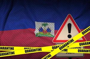 Haiti flag and Covid-19 quarantine yellow tape. Coronavirus or 2019-nCov virus photo