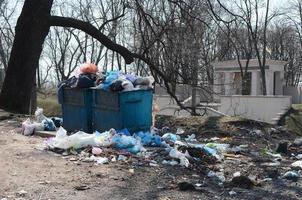 el bote de basura está lleno de basura y desechos. retiro intempestivo de basura en zonas pobladas foto