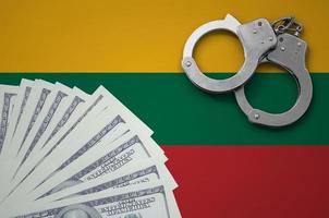 Lithuania flag  with handcuffs and a bundle of dollars. The concept of illegal banking operations in US currency photo