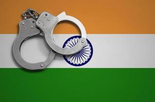 India flag  and police handcuffs. The concept of crime and offenses in the country photo