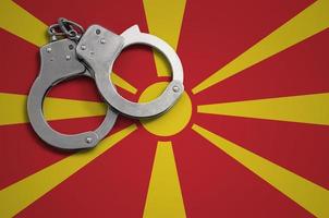 Macedonia flag  and police handcuffs. The concept of crime and offenses in the country photo