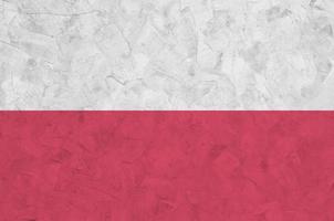 Poland flag depicted in bright paint colors on old relief plastering wall. Textured banner on rough background photo