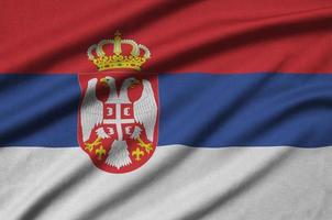 Serbia flag  is depicted on a sports cloth fabric with many folds. Sport team banner photo