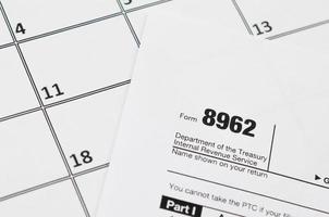 IRS Form 8962 Premium tax cerdit PTC blank lies on empty calendar page photo