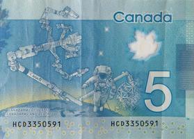 Dextre and canadarm2 on Canada 5 Dollars 2013 Polymer Banknote fragment photo