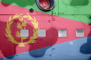 Eritrea flag depicted on side part of military armored helicopter closeup. Army forces aircraft conceptual background photo