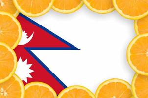 Nepal flag  in fresh citrus fruit slices frame photo