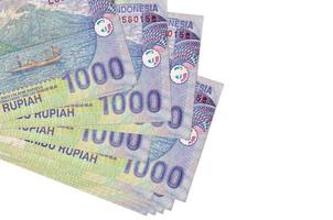 1000 Indonesian rupiah bills lies in small bunch or pack isolated on white. Mockup with copy space. Business and currency exchange photo