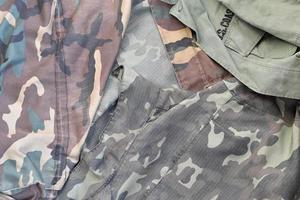 Camouflage background texture as backdrop for military service design projects photo