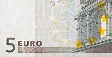 Fragment part of 5 euro banknote close-up with small brown details photo
