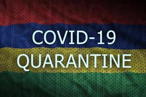 Mauritius flag and Covid-19 quarantine inscription. Coronavirus or 2019-nCov virus photo
