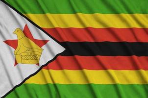 Zimbabwe flag  is depicted on a sports cloth fabric with many folds. Sport team banner photo