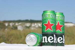 KHARKOV, UKRAINE - JULY 31, 2021 Green tin cans of Heineken lager beer produced by the Dutch brewing company Heineken N.V. photo