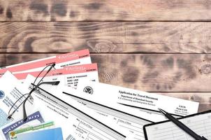 USCIS form I-131 Application for travel document lies on flat lay office table and ready to fill. U.S. Citizenship and Immigration services paperwork concept photo