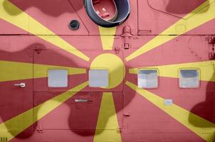 Macedonia flag depicted on side part of military armored helicopter closeup. Army forces aircraft conceptual background photo