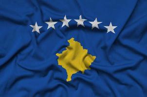 Kosovo flag  is depicted on a sports cloth fabric with many folds. Sport team banner photo
